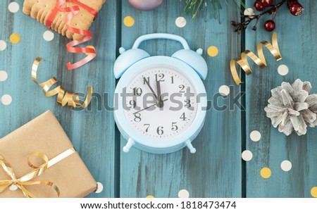 Clock. Christmas wooden background. New Year's holiday. Christmas motive. On a wooden surface. Top view. Free space for your text.