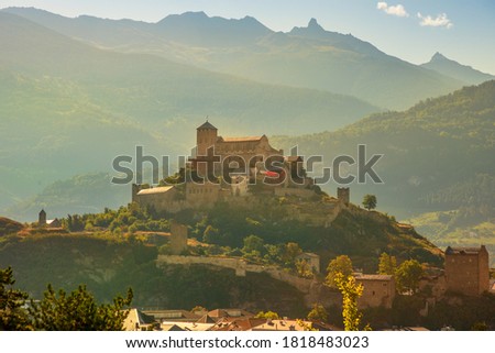 Terraced hills and vineyards aroud Tourbillon Castle and ruins of fortified village of Valere in Sion, capital of canton of Valais. Sion is located in one of most important wine regions in Switzerland Royalty-Free Stock Photo #1818483023