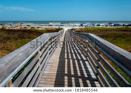 View of a boardwalk leading to East Beach on Galveston Island Texas. Royalty-Free Stock Photo #1818485546
