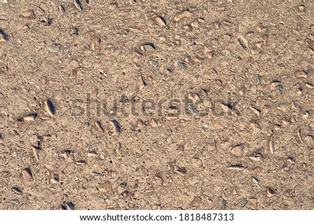 Rocks and concrete. Brown background and cement and pebbles. The old building slab. Brown construction texture.