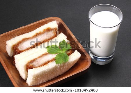 pork cutlet sandwich and glass of milk