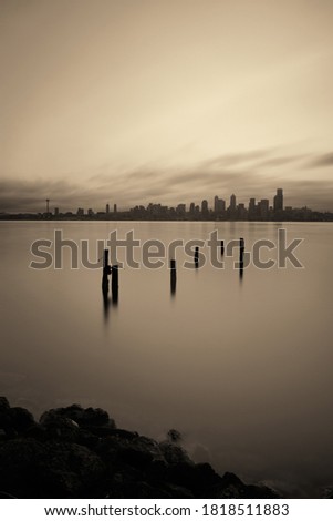Seattle city skyline view with abandoned pier over sea with urban architecture.