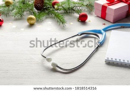 Celebrating Christmas in the health industry. flat lay. Stethoscope with christmas decoration on white background.
