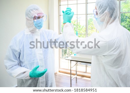Couple male scientist wearing protection suit handshake for success teamwork  at laboratory. Scientist portrait shot