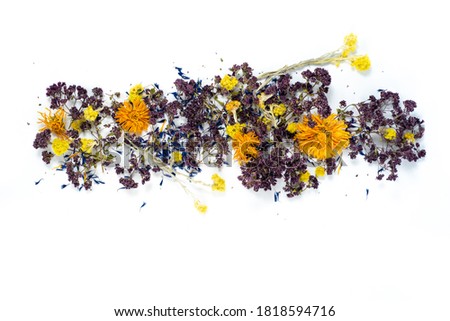 different dried flowers lie heap on a white background