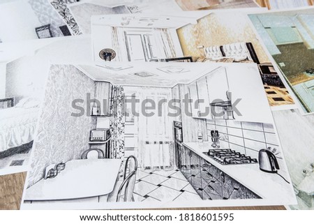 Drawings of a house or apartment are on the table. Designer desk with graphic outline of apartment. Architects project.