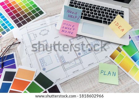 Creative work at office laptop with house sketch , calculator and color sampler. Architect design project