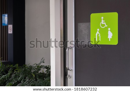 Image of wheelchair or disable person-elderly people-pregnant woman sign or symbol shown on opening slide door of the public toilet background. 
