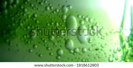 Green water drops, deliberately blurred shot
