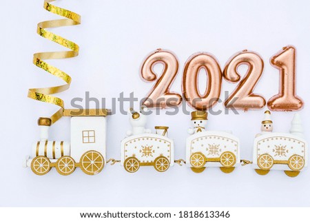 Happy New year 2021. Christmas locomotive with numbers 2021 on a bright white background. Copyspace. Flatlay.