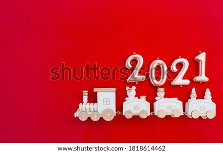 Happy New year 2021. Christmas locomotive with numbers 2021 on a bright red background. Copyspace. Flatlay.