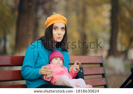 Surprised Mother and Daughter Posing in the Park. Mom and cute baby girl looking at the camera
