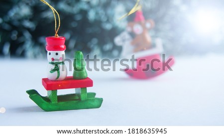  New Year's card, wooden Christmas tree toy. Space for text. New Year's fairy tale. Snowman sledding in a snow forest                            
