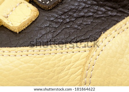 Beige and black leather shoe with stitches for children - details