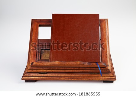 Brown book on wooden reading desk
