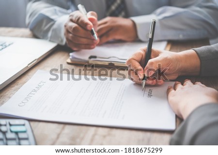 businessman is negotiating, advising, and explaining the matter of the contract to be agreed to sign the contract.
