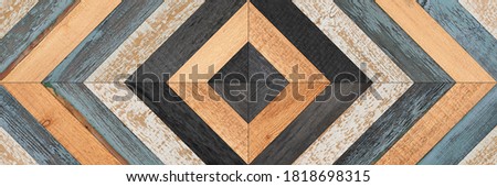 Colorful wooden wall with chevron pattern. Weathered wooden boards texture. Rustic parquet floor element.