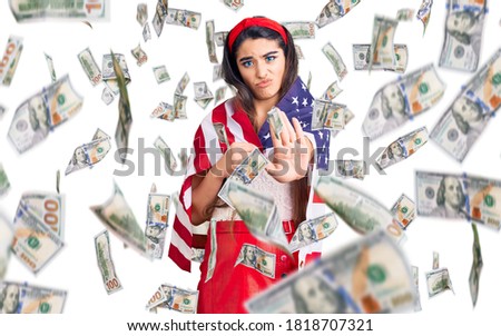 Brunette teenager girl holding united states flag with open hand doing stop sign with serious and confident expression, defense gesture