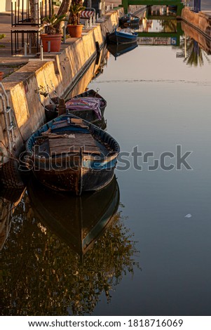 Fishing boats standing next to a water channel