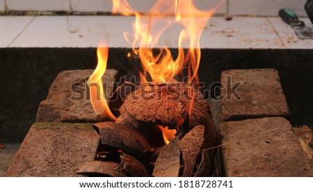 a fire burning on a dry coconut