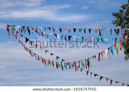 The flag rails beautifully floating in the sky , used to decorate the party.
