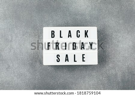 Black friday sale word on lightbox on gray concerete background table. Flat lay, top view