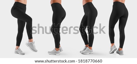 Template of stretch women clothes on the slender legs of the girl, for the presentation of design and pattern. A set of black pants for sports and fitness. Mockup leggings isolated on background Royalty-Free Stock Photo #1818770660