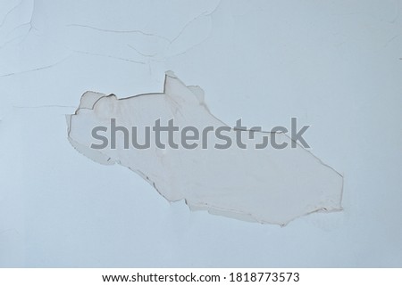 The paint peeling off from wall.