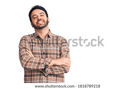 Young hispanic man wearing casual clothes happy face smiling with crossed arms looking at the camera. positive person. 