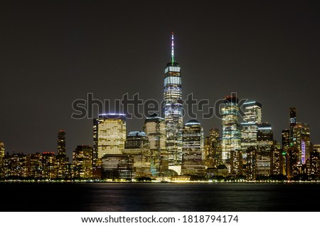 New York City Manhattan NY skyline panorama at night over Hudson river with reflections viewed from New Jersey USA