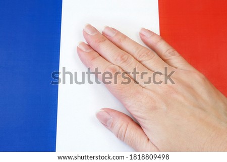 french flag and hand on it. patriotism and loyalty 