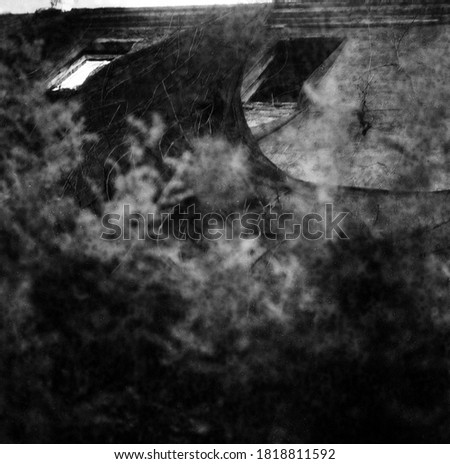 The spirit of the old house. Texture, photo abstraction, background. Close-up, black and white photographic film, no computer editing.