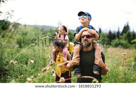 Family with small children hiking outdoors in summer nature. Royalty-Free Stock Photo #1818831293