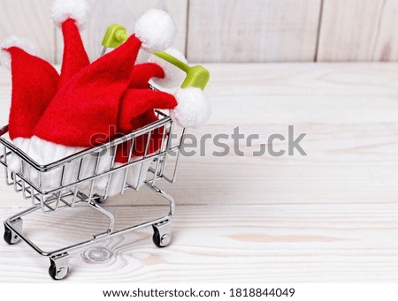 Shopping basket with little santa claus hats. Christmas pattern.
