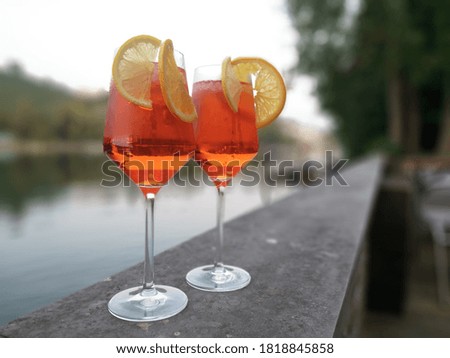 Two drinks by the river on stone wall
