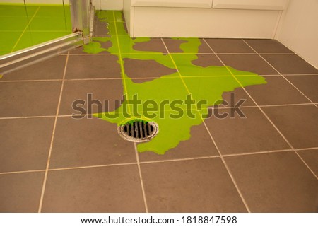 Shower leaking indicator dye flood test to check for leaks withing the shower pan base Royalty-Free Stock Photo #1818847598