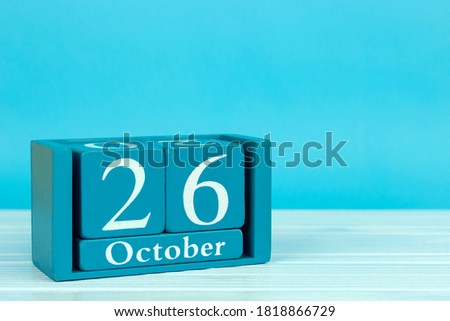 wooden calendar with the date of October 26 on a blue wooden background, International School Libraries Day