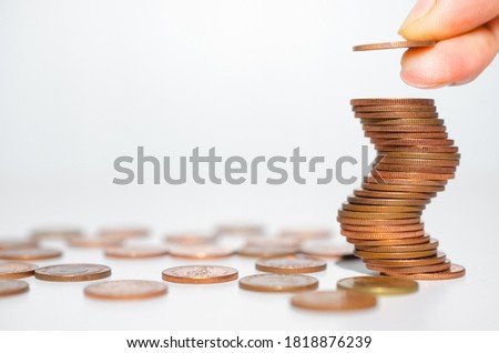 business man hand put copper coin stack growth up isolated on white background. money saving, financial growing, business startup, economy budget and investment concept.