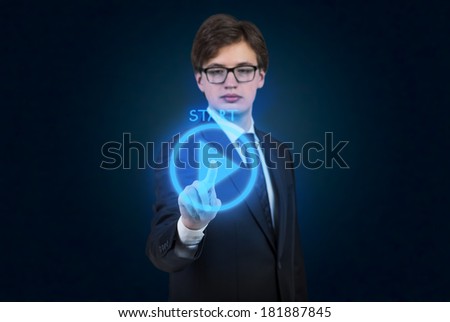 A businessman pushing the 'start' button 
