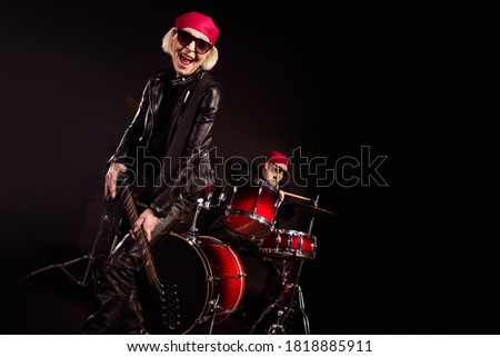 Photo of two retired lady man rock popular band perform concert play drum instruments solo guitar family business wear trendy rocker leather outfit bandana isolated black color background