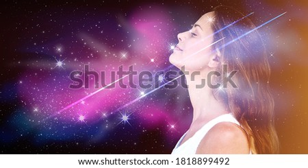 Double exposure portrait of a young woman with galaxy space inside head. Royalty-Free Stock Photo #1818899492