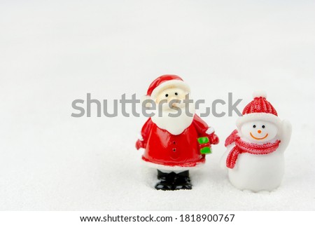 Merry Christmas and happy new year concept. Cute santa claus figure on snow with copy space