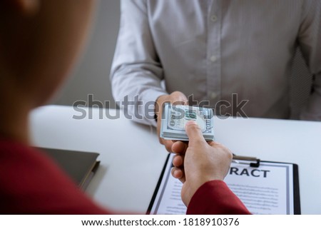 Business woman giving money to bribe an employee of a financial company So that the company's illegal deal was passed, the idea of ​​illegal bribery