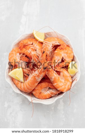 boiled shrimps with fresh lemon in white bowl 
