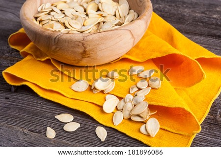 pumpkin seeds in wooden bowl