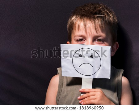 Child holding a sign showing his current mood