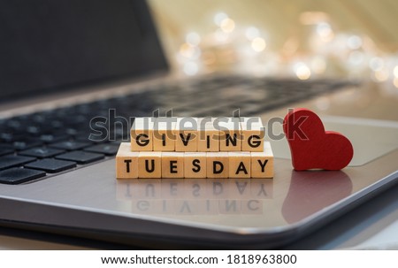 GIVING TUESDAY letter blocks concept on laptop keyboard Royalty-Free Stock Photo #1818963800
