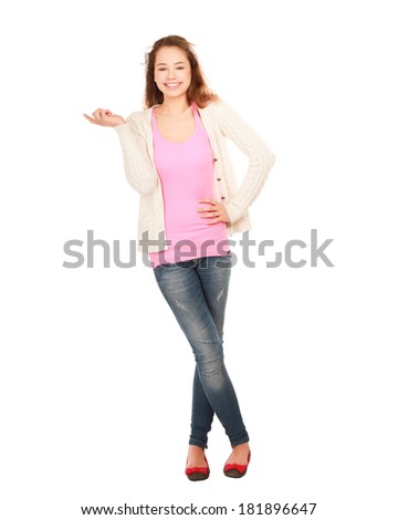 Woman standing in full length isolated on white background and pointing at something.