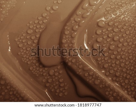 clear water droplets on the surface of brown mica plastic