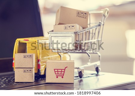 Logistics, supply chain and shipment service for e-commerce, online shopping concept : Boxes of goods, trolley, delivery van on a laptop computer, depicts customers uses internet to order  buy things Royalty-Free Stock Photo #1818997406